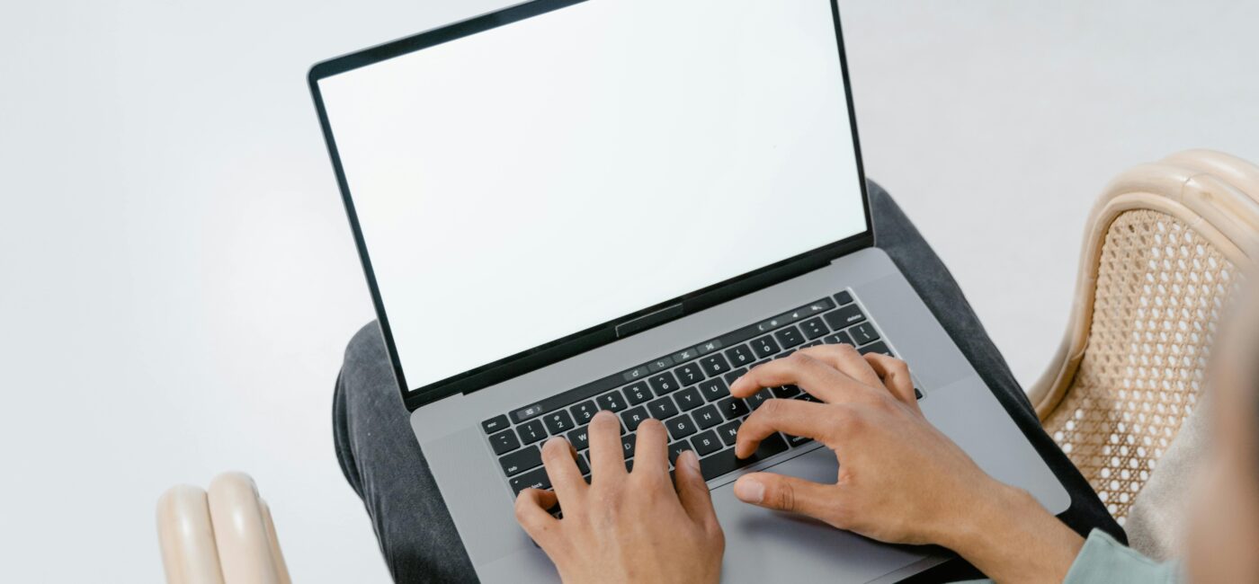 Photo of a person typing on a laptop