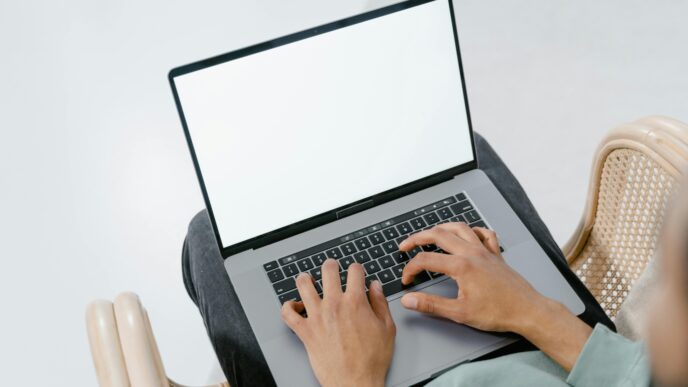 Photo of a person typing on a laptop