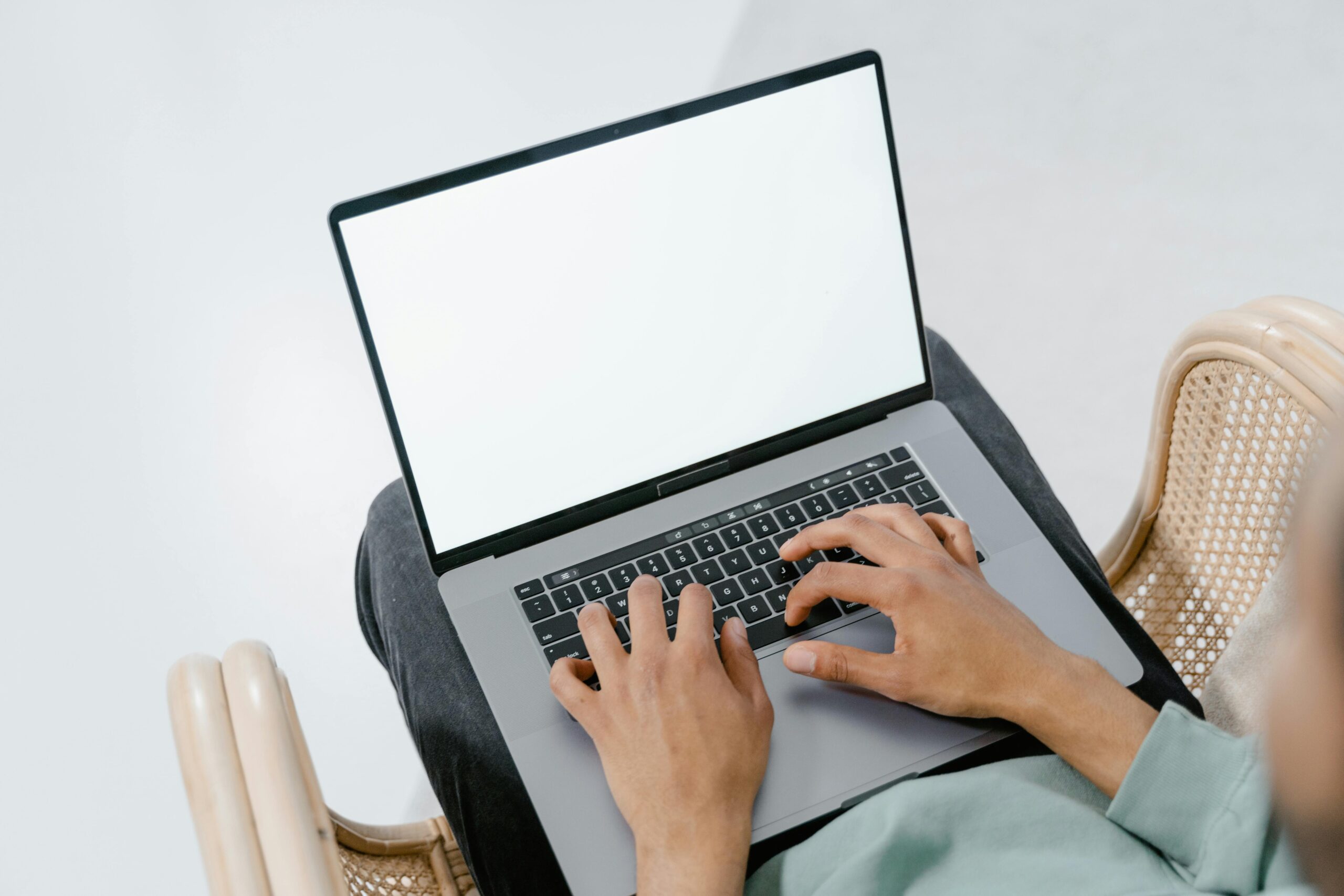 Photo of a person typing on a laptop