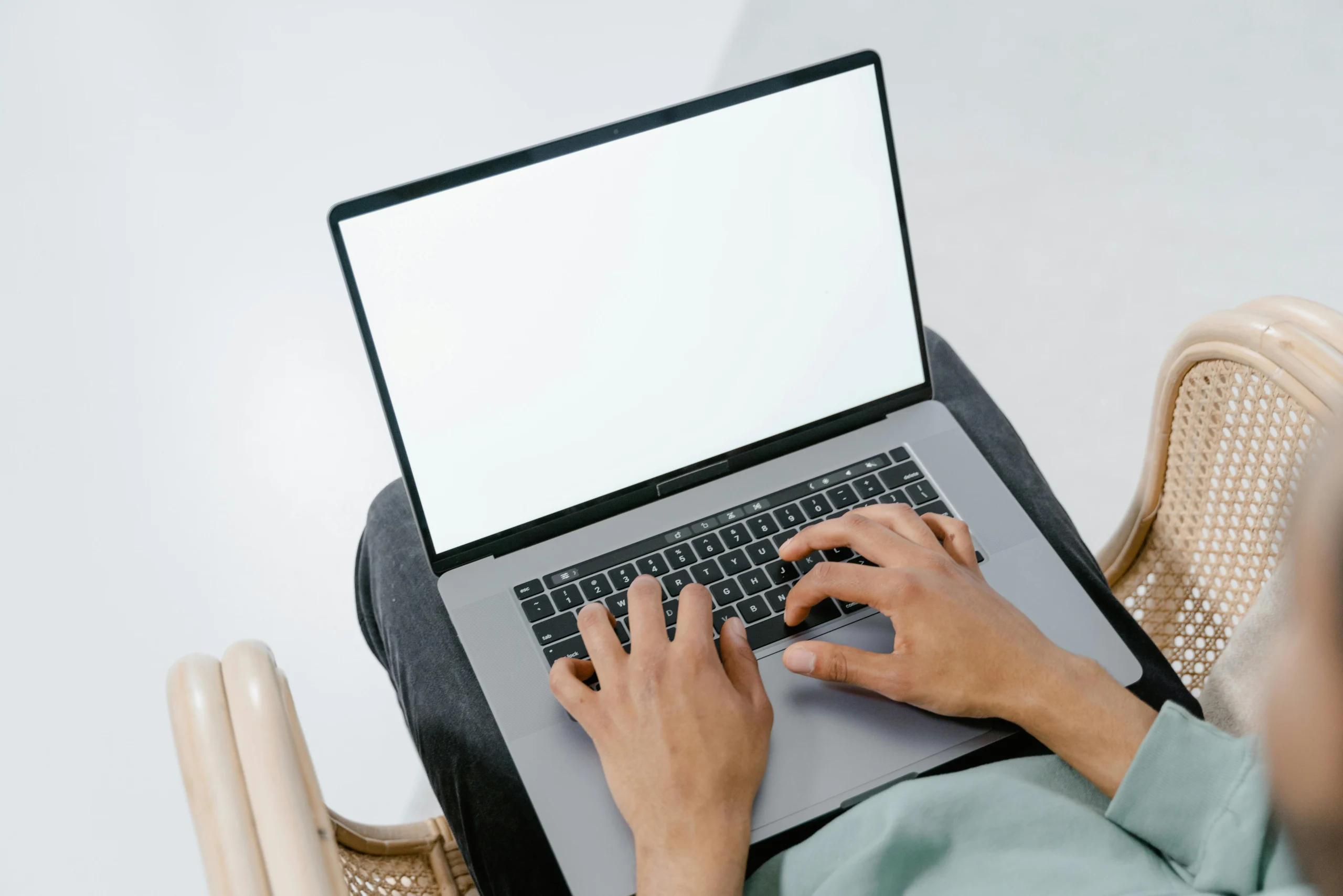 Photo of a person typing on a laptop